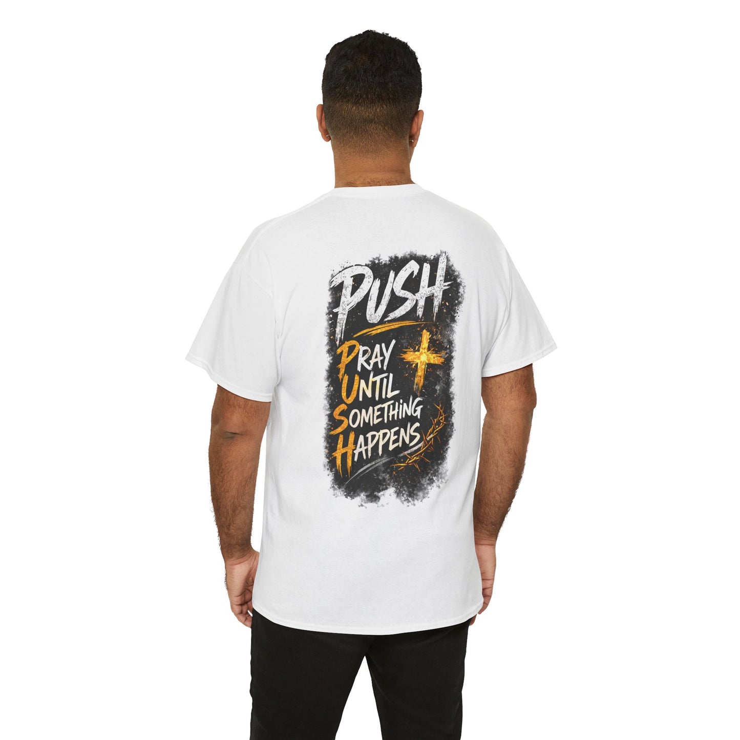 A man viewed from behind wearing a white t-shirt with a large graphic print on the back. The graphic features the word 'PUSH' in white, layered over a black textured background with yellow text reading 'PRAY UNTIL SOMETHING HAPPENS' and a yellow cross.